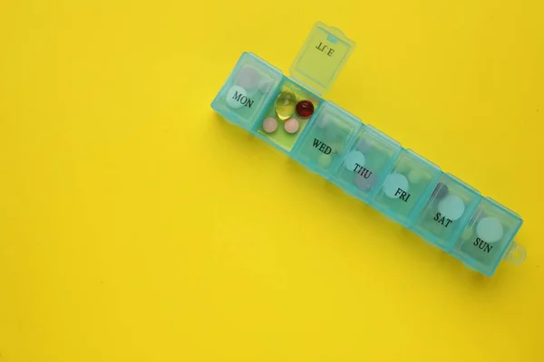 Plastic Box Different Pills Yellow Background Top View Space Text — Stock Photo, Image