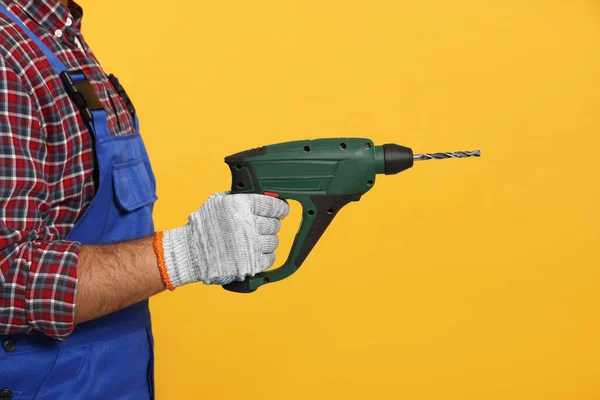 Worker Uniform Power Drill Yellow Background Closeup — стоковое фото