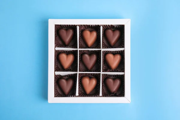 Tasty Heart Shaped Chocolate Candies Light Blue Background Top View — Stockfoto