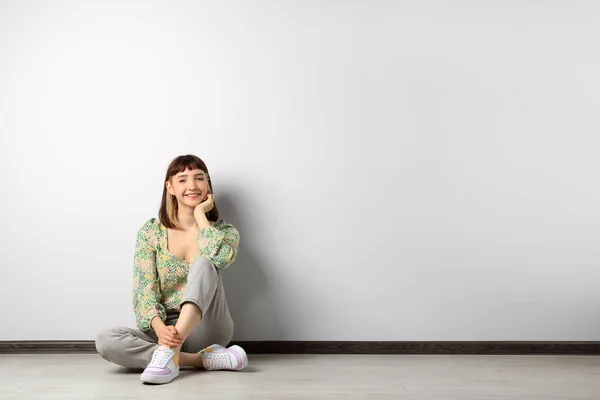 Beautiful Young Girl Sitting Floor White Wall Space Text — ストック写真