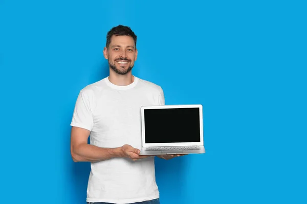 Happy Man Holding Laptop Light Blue Background Space Text — ストック写真