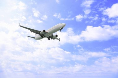 Airplane flying high in blue sky. Modern aircraft