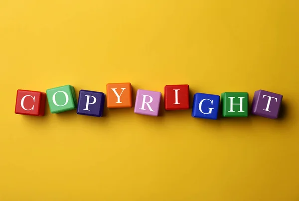 Plagiarism Concept Word Copyright Made Color Cubes Yellow Background Top — Foto de Stock