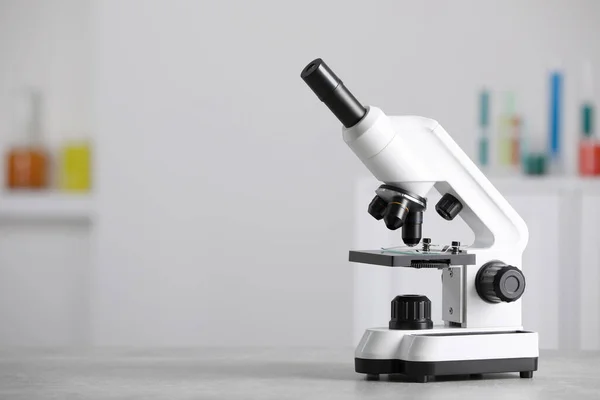 Modern Medical Microscope Grey Table Laboratory Space Text — Φωτογραφία Αρχείου