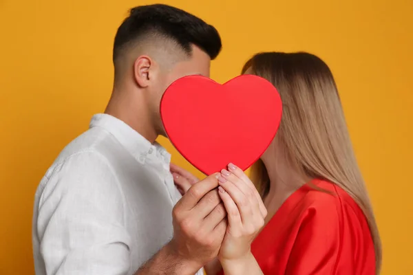 Lovely Couple Kissing Decorative Heart Yellow Background Valentine Day Celebration — Stock Photo, Image