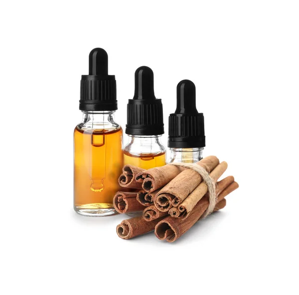 Bottles Natural Essential Oil Dry Cinnamon Sticks White Background — Stockfoto