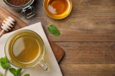 Buckwheat tea, granules and honey on wooden table, flat lay. Space for text
