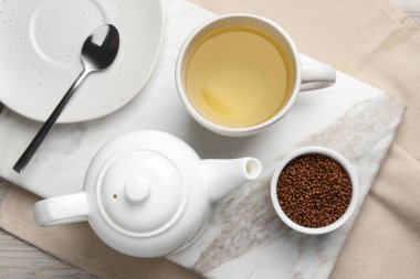 Freshly made buckwheat tea and granules on table, top view