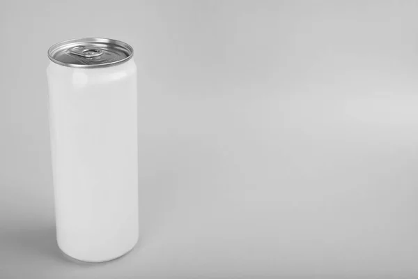 White can of energy drink on light grey background. Space for text