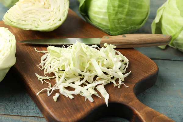 stock image Chopped cabbage on blue wooden table, closeup