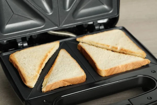 Modern Sandwich Maker Bread Slices Wooden Table Closeup — стоковое фото