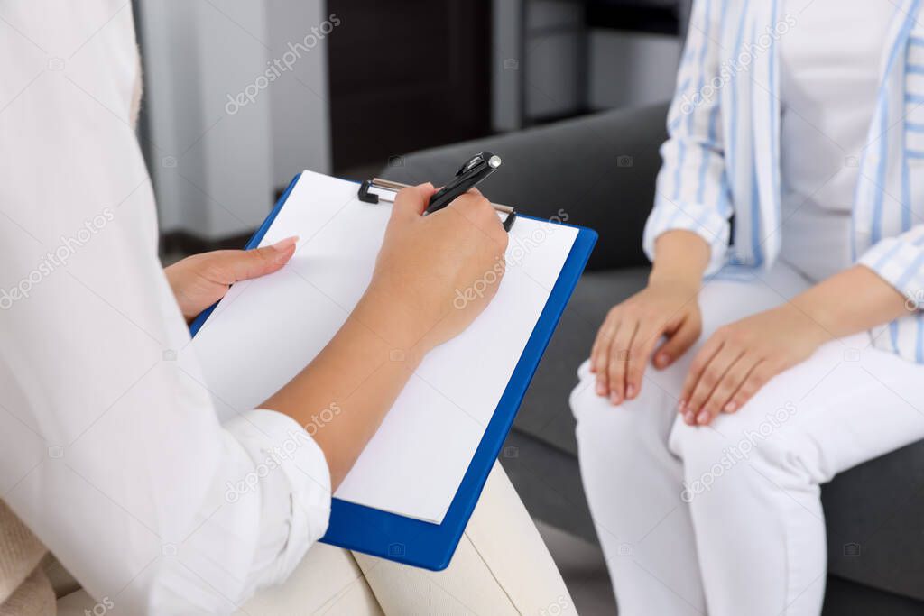 Professional psychologist working with woman in office, closeup