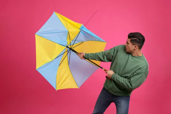 Man Umbrella Caught Gust Wind Pink Background — Stok fotoğraf