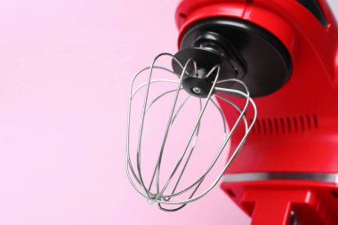 Modern red stand mixer on pink background, closeup
