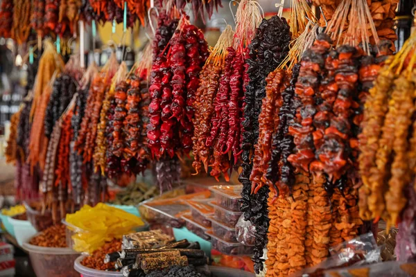 Bunches of different delicious churchkhelas at market