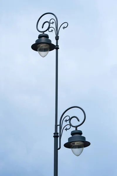 Beautiful vintage street lamp against cloudy sky