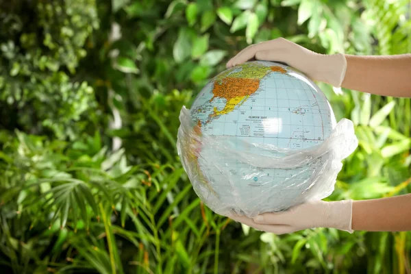 Woman Holding Globe Plastic Bag Green Leaves Closeup Space Text — Stock Fotó