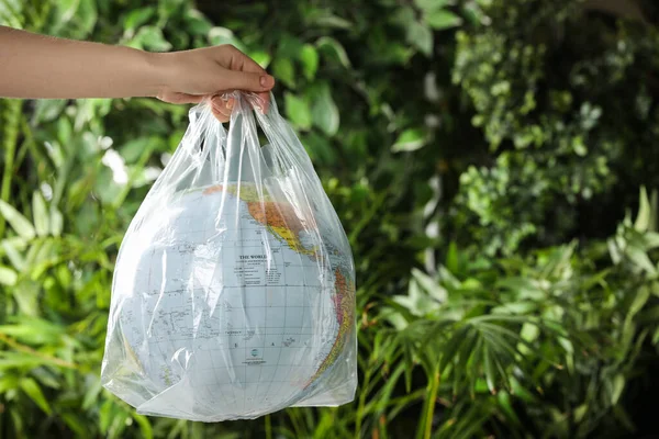 Woman Holding Globe Plastic Bag Green Leaves Closeup Space Text —  Fotos de Stock