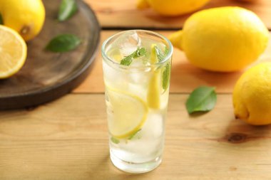 Soğuk taze limonata ve ahşap masada meyveler.