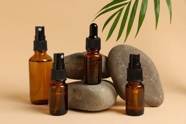 Bottles Organic Cosmetic Products Green Leaf Stones Beige Background — Φωτογραφία Αρχείου