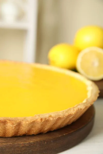 Delicious homemade lemon pie on white wooden table, closeup