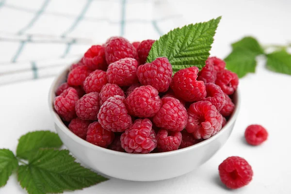 Bowl Fresh Ripe Raspberries Green Leaves White Table — Stock Fotó