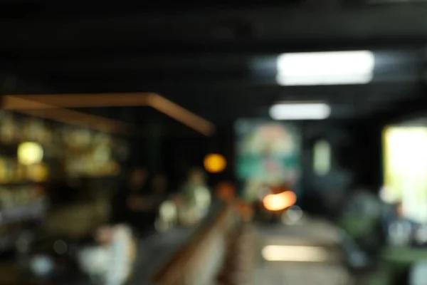 Blurred view of stylish modern bar interior with bokeh effect