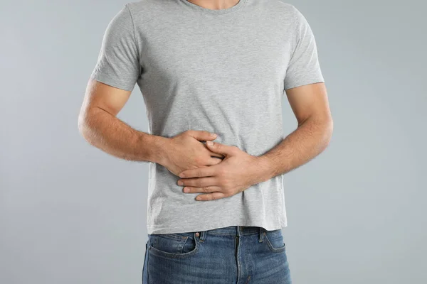 Man Suffering Liver Pain Grey Background Closeup — Stock Photo, Image