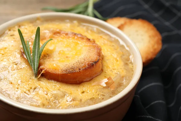 Tasty homemade french onion soup on table, closeup