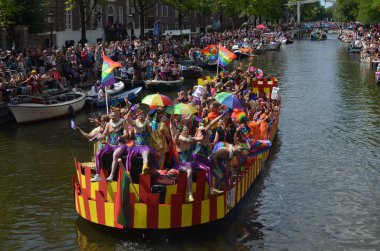 AMSTERDAM, NETHERLANDS - AUGUST 06, 2022: Many people in boats at LGBT pride parade on river