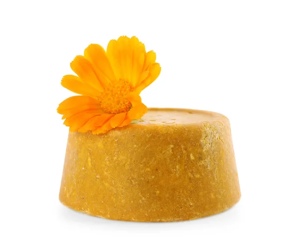 Yellow solid shampoo bar and flower isolated on white. Hair care