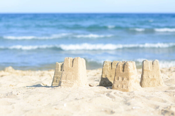 Beautiful sand castles on beach near sea