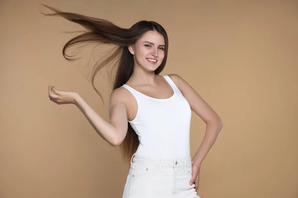 Young Woman Strong Healthy Hair Beige Background — стоковое фото