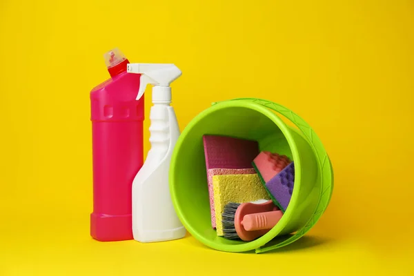 Green Bucket Cleaning Supplies Tools Yellow Background — Zdjęcie stockowe