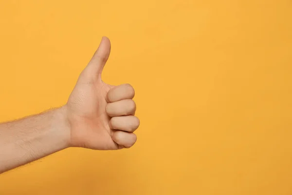 Man Showing Thumb Orange Background Closeup Space Text — Foto de Stock