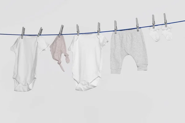 Different Baby Clothes Drying Laundry Line Light Background — Fotografia de Stock