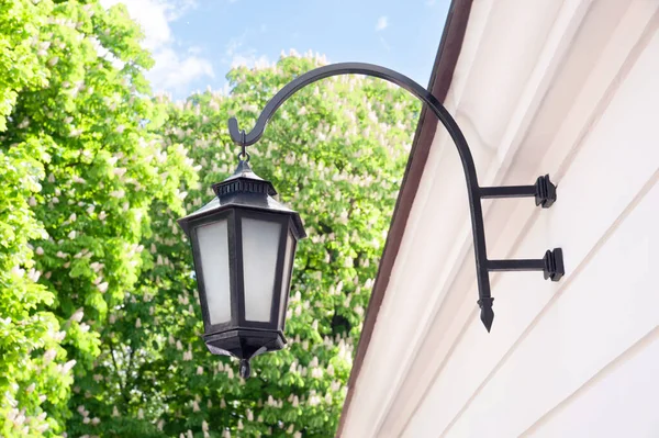 Vintage street lamp on wall of building outdoors, low angle view