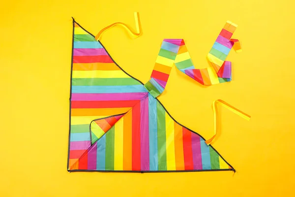 Bright Rainbow Kite Yellow Background Top View — Stockfoto