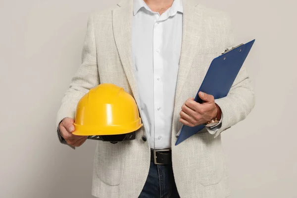 Professional engineer with hard hat and clipboard on white background, closeup
