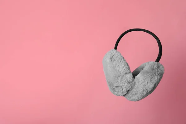 Stylish Winter Earmuffs Pink Background Space Text — стоковое фото