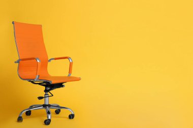 Sarı arka planda modern ofis koltuğu. Metin için boşluk