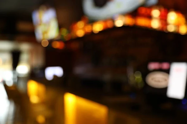 Blurred view of stylish modern bar interior with bokeh effect