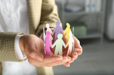 Arka planda bulanık insan figürleri tutan kadın, yakın plan. Çeşitlilik ve kapsama kavramı