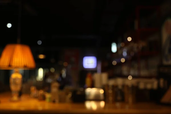 Blurred view of stylish modern bar interior with bokeh effect