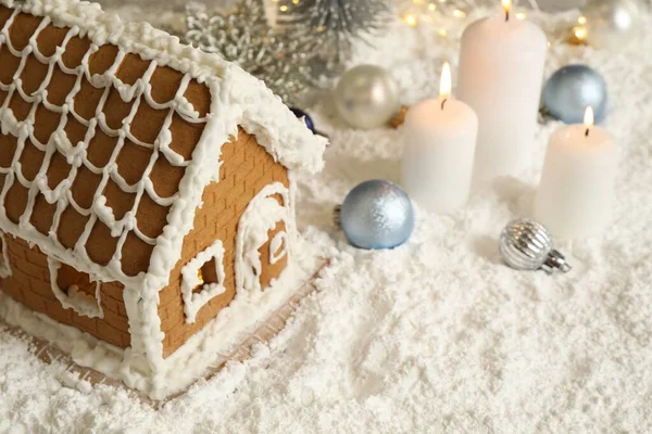 Beautiful gingerbread house and Christmas decor on snow
