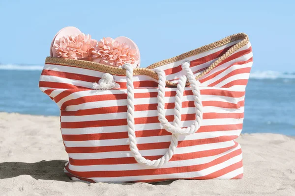 Stylish Striped Bag Slippers Sandy Beach Sea — Stock Photo, Image