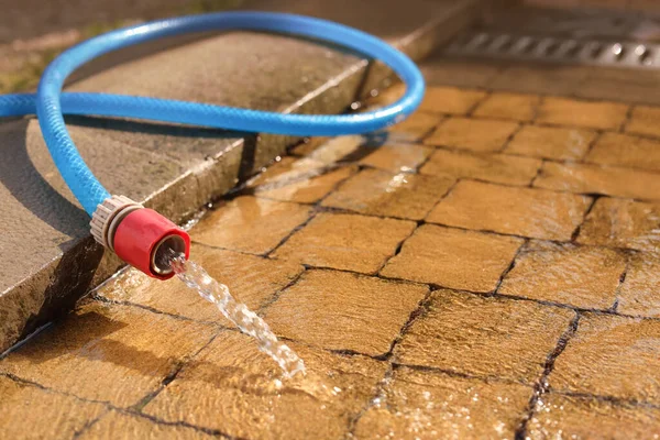 Water Flowing Hose Stone Floor Outdoors Closeup Space Text — 图库照片