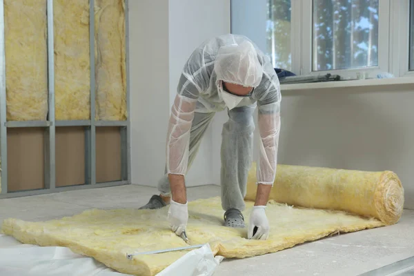 Worker Measuring Cutting Insulation Material Indoors — Stockfoto