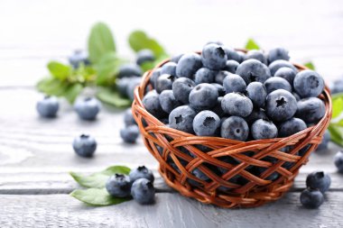 Tasty fresh blueberries on wooden table, closeup. Space for text