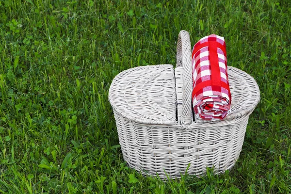 Rolled Checkered Tablecloth Picnic Basket Green Grass Outdoors Space Text — Φωτογραφία Αρχείου